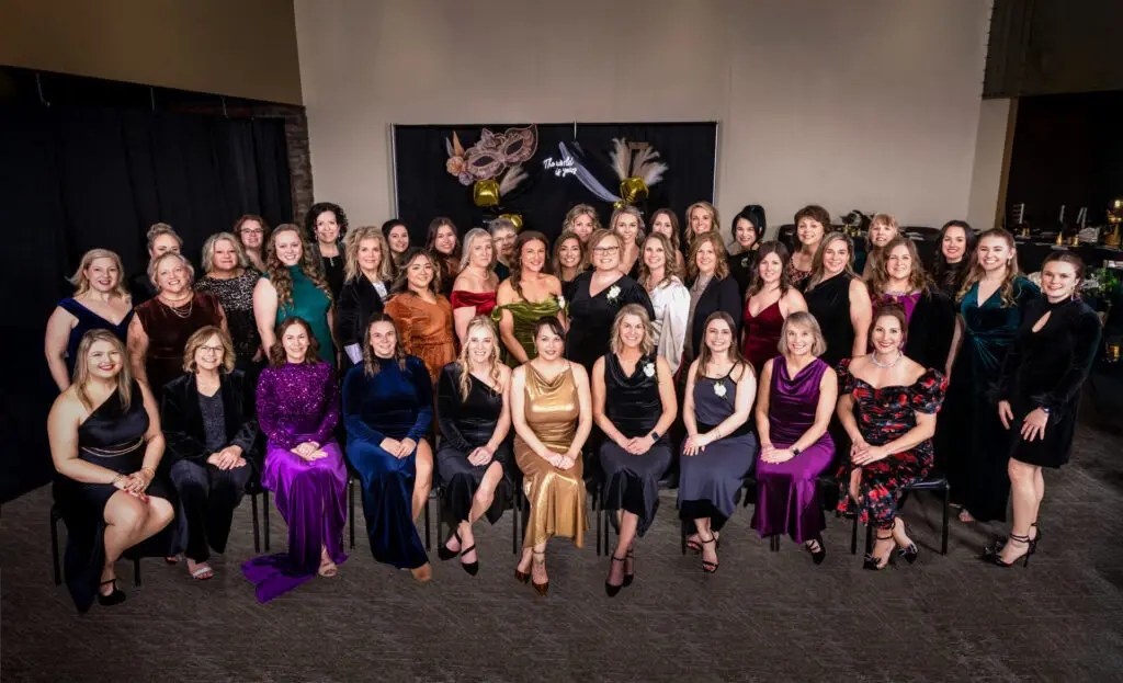 Annual group photo of Owatonna Business Women board members and previous award winners gathered for a recognition event in Owatonna, Minnesota.