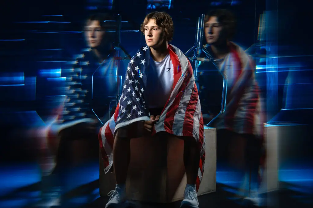Male athlete posing with American flag during sports portrait session